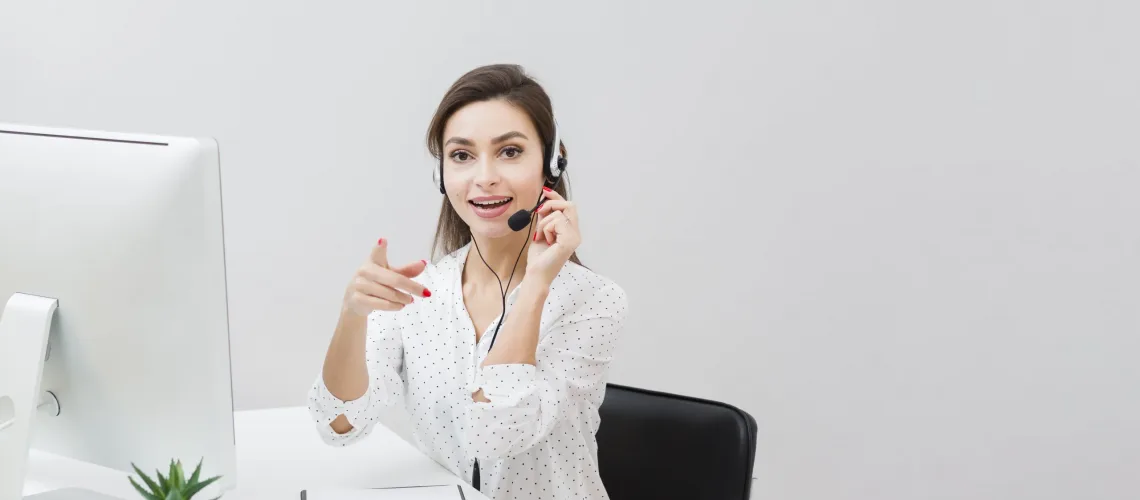 front-view-woman-desk-wearing-headset-pointing