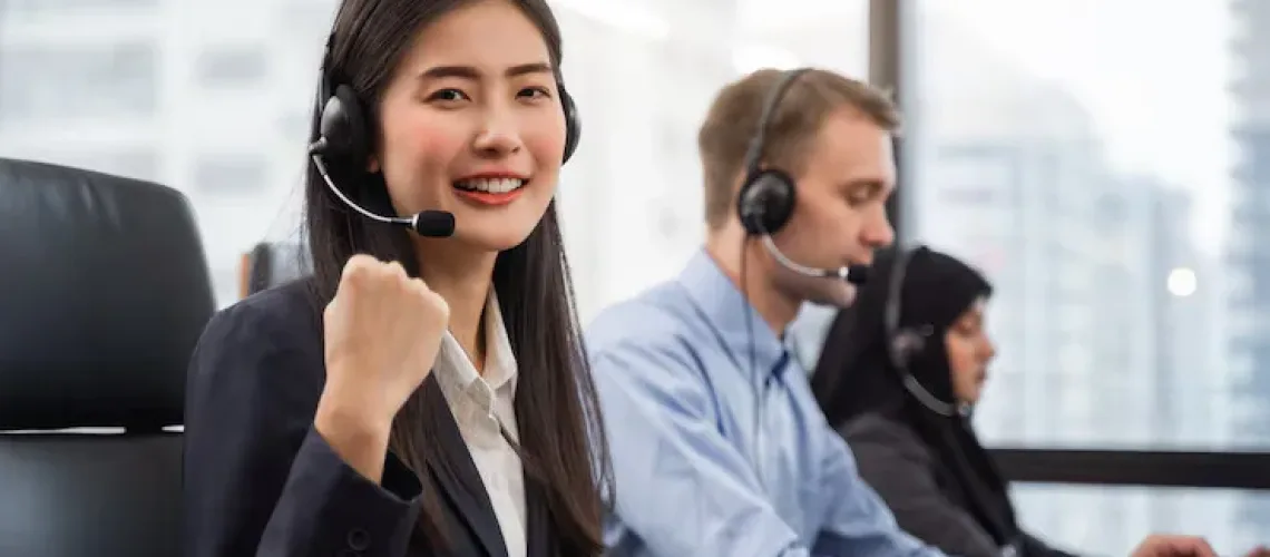 happy-smiling-asian-woman-call-center-operator-wearing-headsets-working-computer-talking-with-customer-with-her-service-mind_33413-367