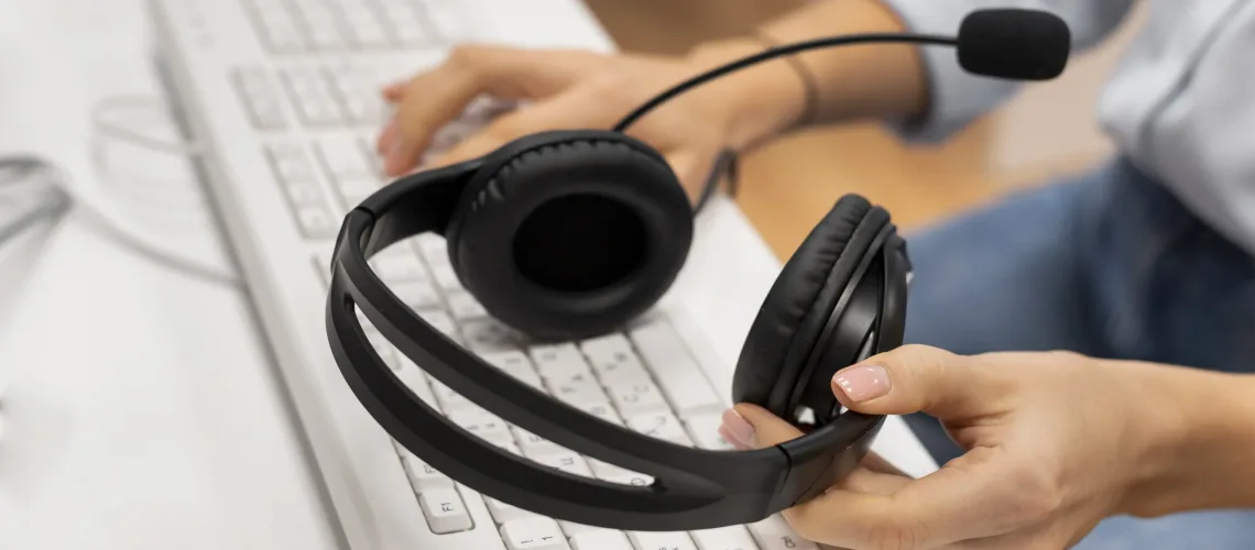 woman-working-call-center-holding-pair-headphones